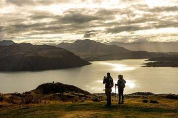 Couple Taking Mobile Photos of Lake Wanaka View in Autumn