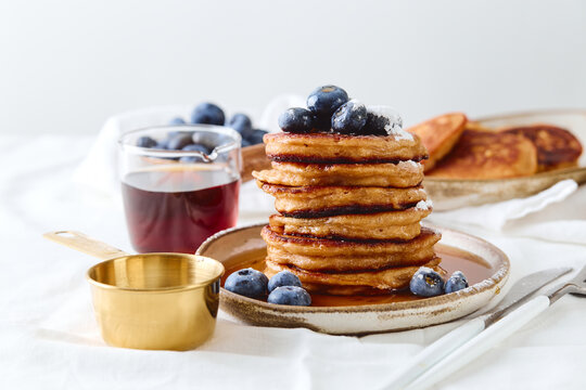 Stack of pancakes with blueberries and syrup