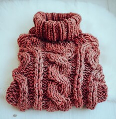 A deep rose cable-knit turtleneck