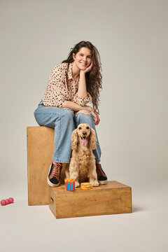 Woman with cocker spaniel posing in casual setting