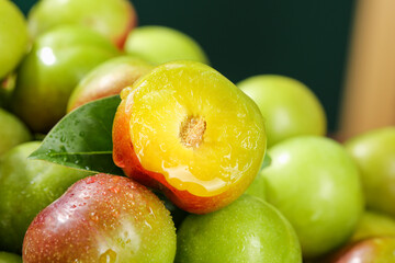 Fresh Ripe Plums Cut in Half Showing Yellow Flesh - Healthy Organic Stone Fruit Display