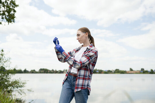 Young female biologist conducting field research
