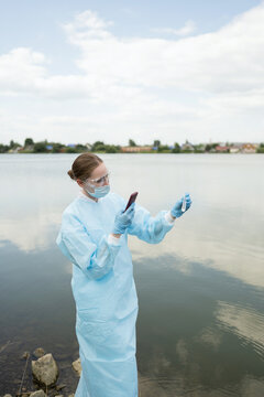 Young biologist conducting water analysis outdoors