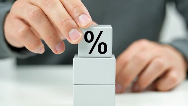 Concept of interest rates and finance growth represented by percentage symbol on wooden blocks