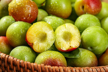 Fresh Cut Plums in Basket Showing Yellow Flesh with Water Drops - Healthy Organic Stone Fruit Display