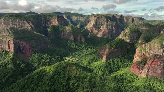 Aerial view of the rugged Amboro National Park, its steep cliffs and lush green forests creating a stunning contrast of textures and tones, Samaipata, Bolivia.
