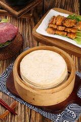 Asian Food Spread with Steamed Tortillas Bamboo Steamer Grilled Skewers Raw Meat Traditional Wooden Table Setting