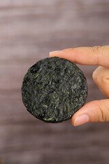 Dried Kelp Cake from Dalian Xiapu China - Traditional Organic Seaweed Drying Process Hand Held