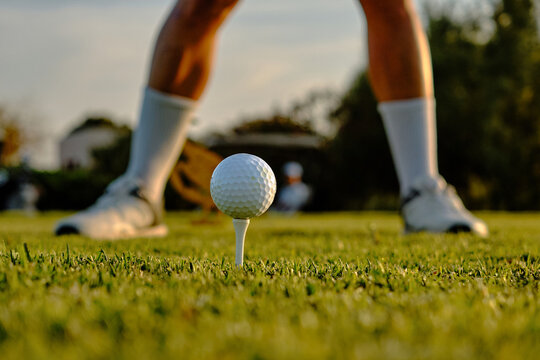 Golf ball ready for tee-off on lush green field