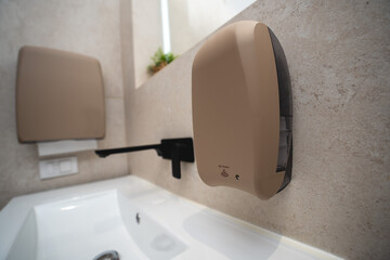Sandy texture touchless soap dispenser in a luxury bathroom