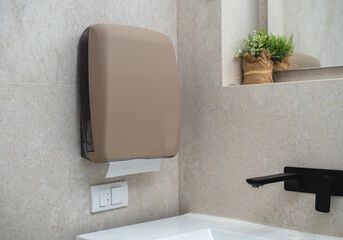 Sandy texture paper towel dispenser in modern bathroom