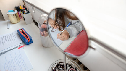 Girl studying diligently in a cozy home setup