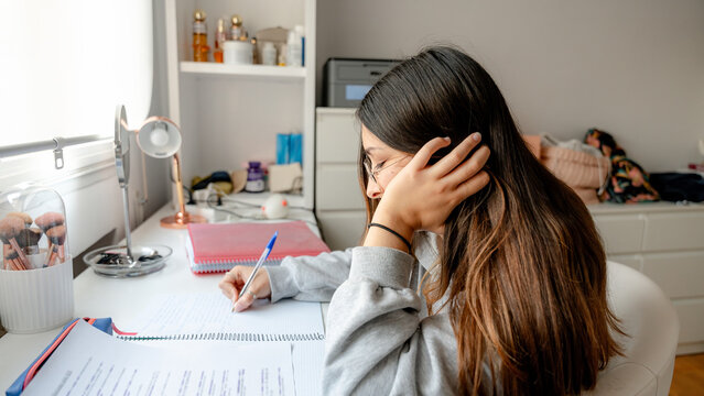 Girl studying at desk in cozy home environment