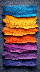 Bright torn paper strips stacked in vivid contrast