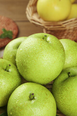 Fresh Green Dangshan Pears with Water Drops Display in Wicker Basket