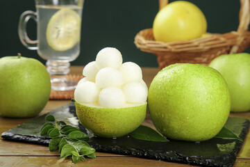 Fresh Green Pears with White Flesh Balls on Slate Board - Healthy Natural Fruit Display