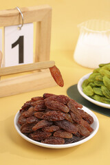Xinjiang Red and Green Dried Raisins with Light Background and Wooden Utensils Food Photography