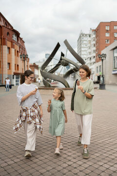 Family enjoying a summer day in the city with ice cream