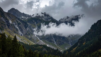 Misty mountains embrace alpine waterfalls