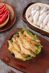 Deep-Fried Fish Fillets with Fresh Vegetables and Traditional Asian Ingredients on Wooden Serving Plates