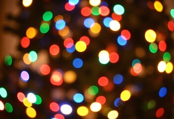 Defocused christmas tree with colorful lights bokeh