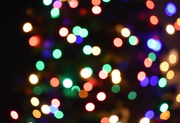 Defocused christmas tree with colorful lights bokeh