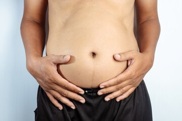 Man holding his fat belly