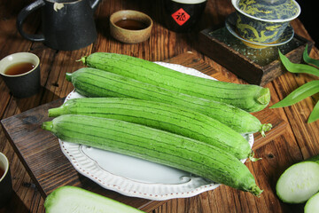 Freshly Picked Loofah Gourds from Shouguang Farm with Traditional Tea Setting