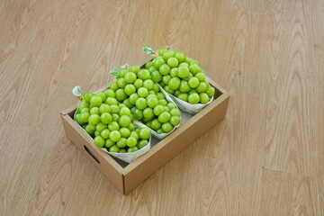 Fresh Green Seedless Grapes in Gift Box on Wooden Floor - Premium Quality Fruit