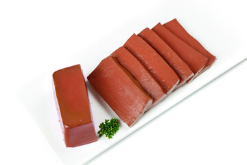 Fresh Raw Tuna Steaks Sliced on White Plate with Parsley Garnish Isolated on White Background