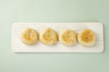 Traditional Golden Mooncakes on Wooden Board - Delicious Asian Pastry Baked Goods