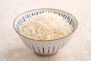 A cookd steamed white rice in a Traditional bowl.