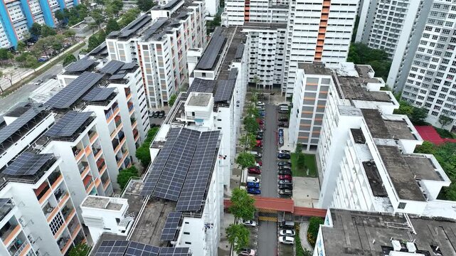 Aerial view of buildings covered with solar panels, contrasting against the cityscape, creating a blend of urban and sustainable energy, Singapore, Singapore, Singapore.