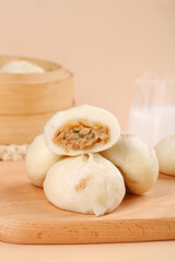 Chinese Steamed Pork Buns Xiao Long Bao Dumplings Traditional Asian Breakfast Food on Wooden Board