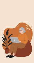 Happy senior woman comfortably using a laptop on a beanbag chair at home. Embracing modern technology, online learning, and independent digital lifestyle.
