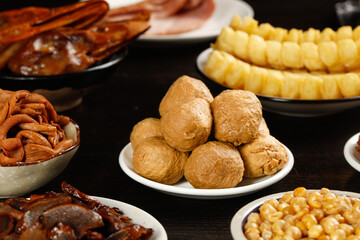 Assorted Asian Gourmet Snacks and Traditional Sweet Treats on Wooden Table