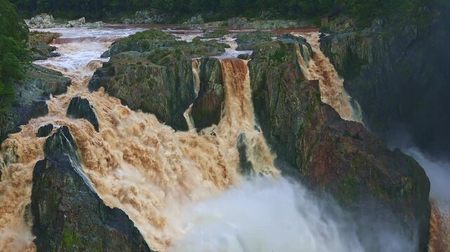 Majestic Barron Falls cascading through lush rainforest