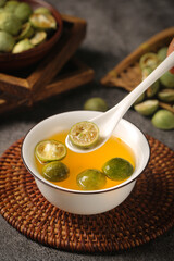 Kumquat Fruit Tea with Fresh Citrus Slices in Ceramic Bowl - Healthy Asian Beverage