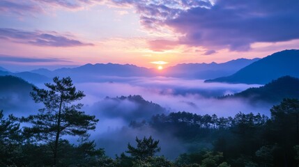 A stunning panoramic view of a misty sunrise over a mountain range with the sun breaking through the clouds.