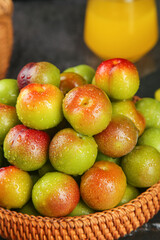 Fresh Ripe Plums with Water Droplets in Wicker Basket - Colorful Stone Fruit