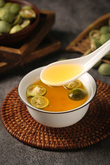 Kumquat Tea with Honey and Citrus Slices in Traditional Asian Setting