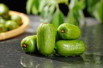 Fresh Green Kiwi Berries on Dark Surface - Exotic Mini Fruit Still Life