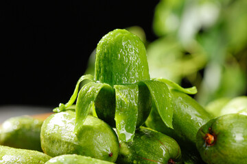 Fresh Mini Kiwi Fruits with Water Drops on Dark Background