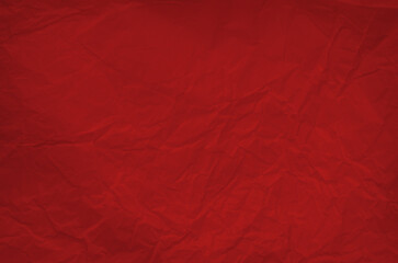 Fototapeta premium Bright red background displays a crumpled texture, ideal for use in graphic design, presentations, or artistic displays. The vivid color adds energy to visual projects. Copy space for Christmas Xmas 
