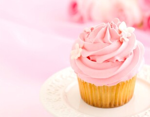 Pink cupcake with delicate frosting and decorations