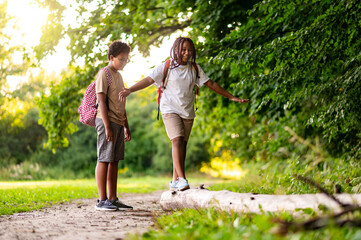 Fototapeta premium Two teens having a walk in the park after school