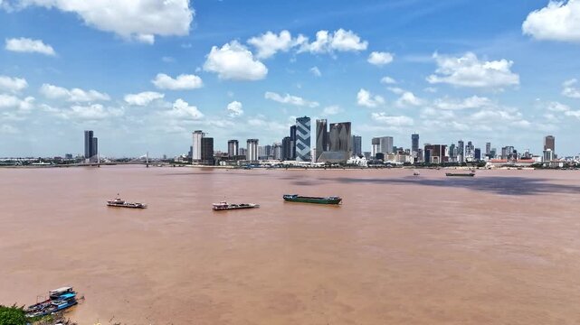 Aerial drone hyperlapse footage above the Mekong river, crossing point from Areyksatr to Phnom Penh, capital city of Cambodia