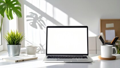 Fototapeta premium Laptop Workspace Sunlit Desk with Blank Screen for Mockup