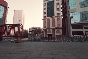 Fototapeta premium different style roadside buildings, surrounded by fences and some pigeons.