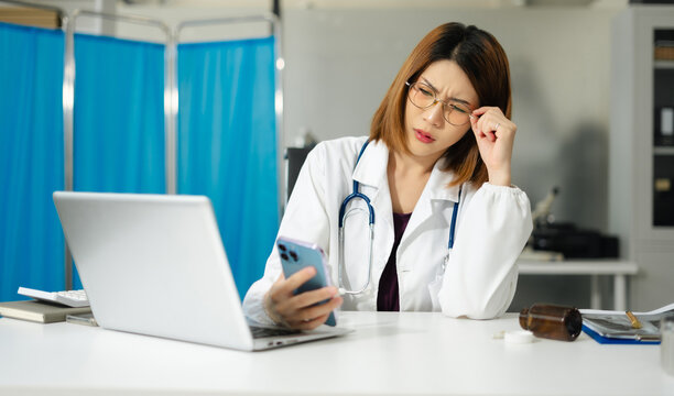 Medical students eyestrain fatigued from computer work, stressed woman overworked with fatigue sit at office table using laptop.